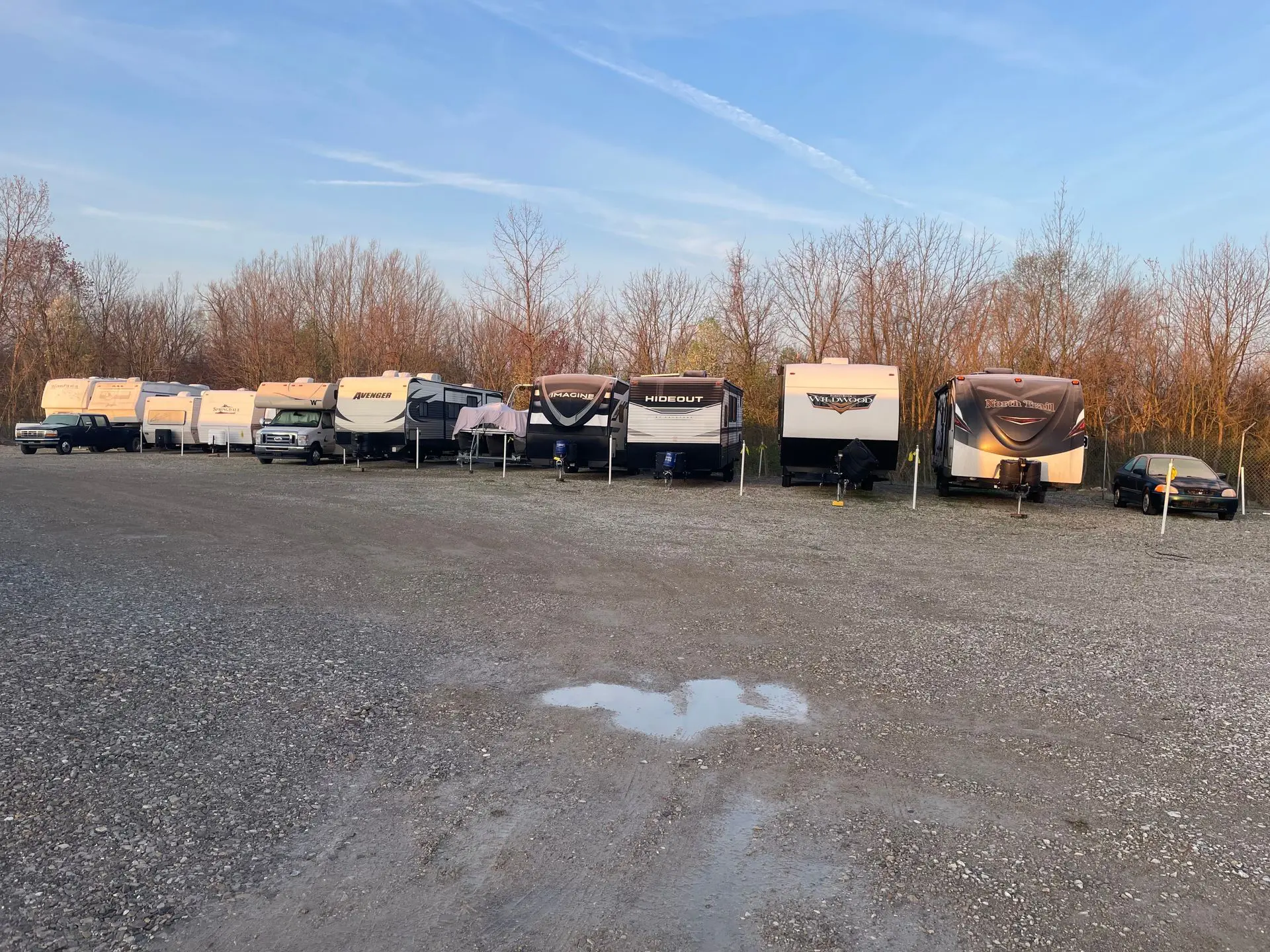 RVs lined up in a gravel lot
