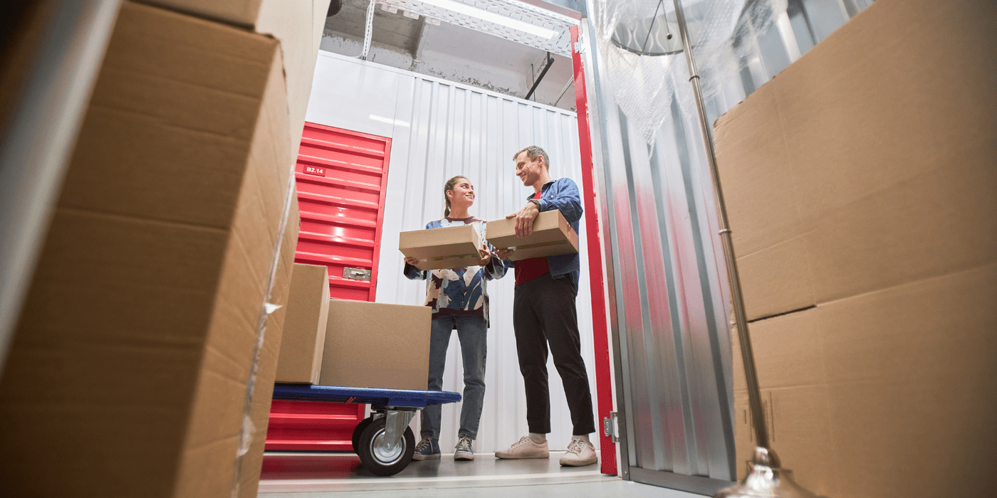 People organizing boxes in storage unit